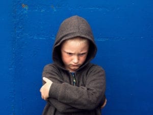 upset boy with arms crossed