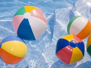 beach balls floating in pool